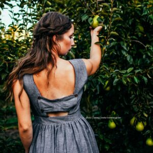 Meadow | Ash - Charcoal Gray Bridesmaid Dress With Full Gathered Knee Length Skirt. Cap Sleeves + Back Bow Panel Pockets