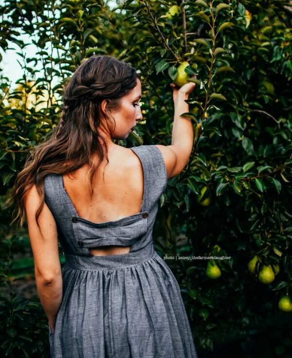 Meadow | Ash - Charcoal Gray Bridesmaid Dress With Full Gathered Knee Length Skirt. Cap Sleeves + Back Bow Panel Pockets