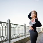 We're loving this riverside athleisure look! Sleek grey leggings paired with a striped sports bra and black cardigan create a stylish yet comfy ensemble. Our favourite trick? The pop of coral adds a trendy edge. Discover more waterfront fashion tips on the blog!